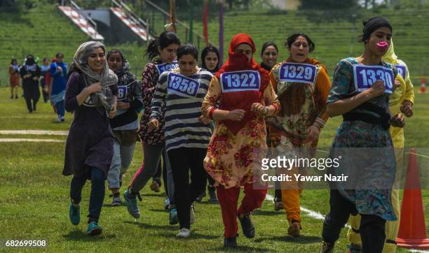 Kashmiri girls run to qualify the test during an Indian police recruitment rally on May 13, 2017 in Srinagar, the summer capital of Indian...