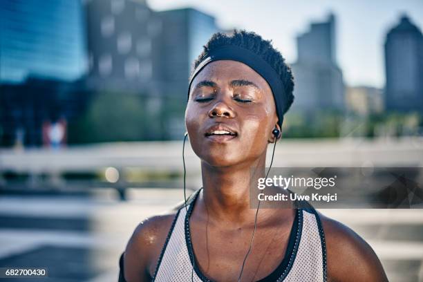 portrait of young female runner - sweating stock-fotos und bilder