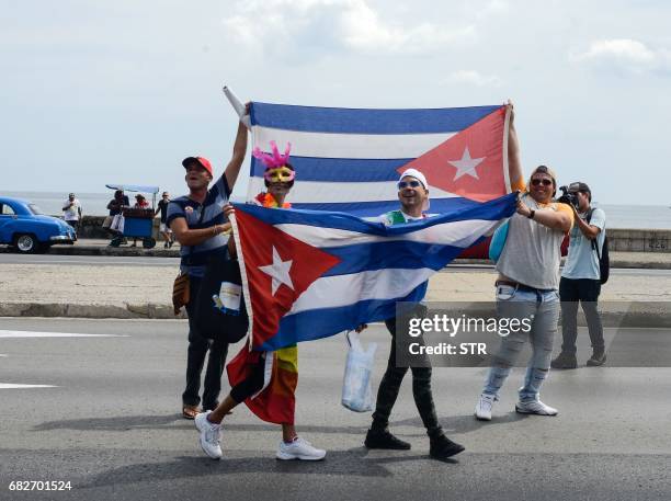 Participants in the gay pride parade carry Cuban flags during the celebration of the day against homophobia and transphobia in Havana, on May 13,...