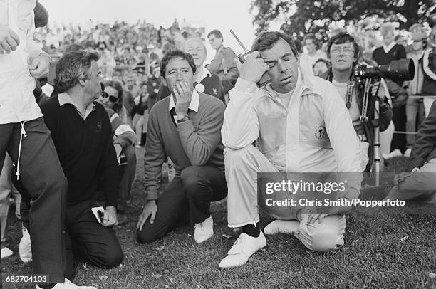 English golfer and non-playing captain, Tony Jacklin pictured right with Spanish golfer Manuel Pinero of Team Europe as they watch the action to win...