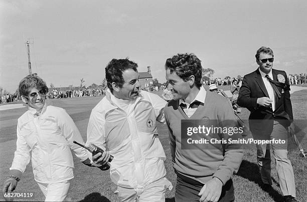 English golfer and non-playing captain, Tony Jacklin pictured centre congratulating Spanish golfer Manuel Pinero of Team Europe during action to win...