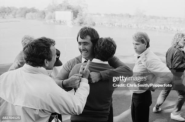 English golfer and non-playing captain, Tony Jacklin pictured left congratulating Spanish golfer Seve Ballesteros as English golfer Paul Way looks on...