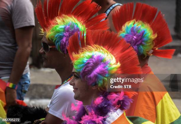 People participate in the gay pride parade during the celebration of the day against homophobia and transphobia in Havana, on May 13, 2017. / AFP...