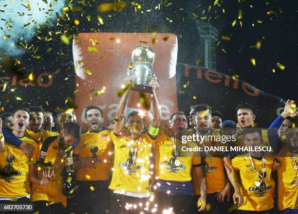 Coach Gheorghe Hagi of Viitorul Constanta celebrates with the team and trophy the victory against CFR Cluj and winning of the Championship after the...