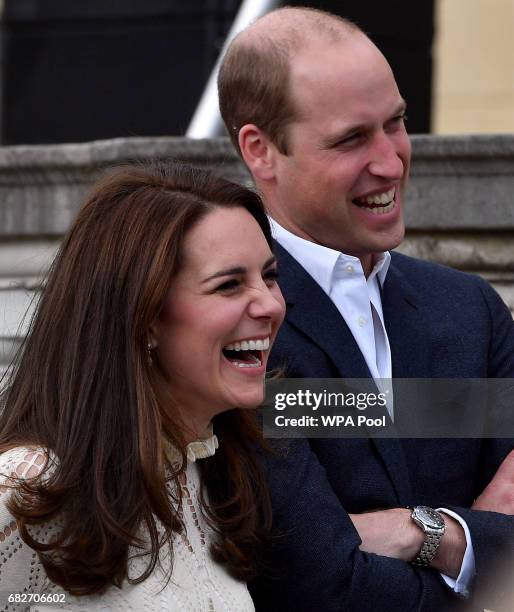 Catherine, Duchess of Cambridge and Prince William, Duke of Cambridge laugh as they host a tea party in the grounds of Buckingham Palace to honour...