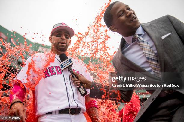 Deven Marrero of the Boston Red Sox reacts after getting doused with a Powerade shower while being interviewed by NESN anchor Jahmai Webster after a...