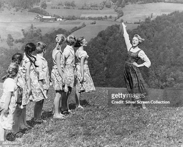 English actress and singer Julie Andrews as the young nun Maria, teaching the von Trapp children to sing in the musical film 'The Sound of Music',...