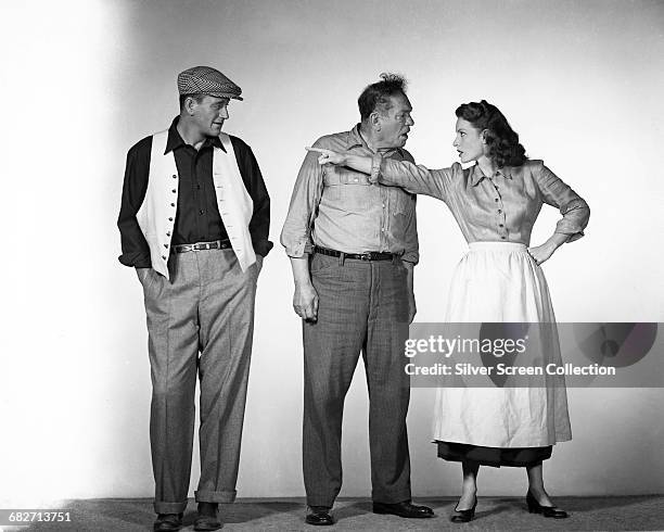 From left to right, actors John Wayne as Sean Thornton, Victor McLaglen as Squire 'Red' Will Danaher and Maureen O'Hara as Mary Kate Danaher in a...