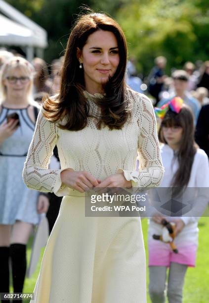 Catherine, Duchess of Cambridge is seen as they host a tea party in the grounds of Buckingham Palace to honour the children of those who have died...