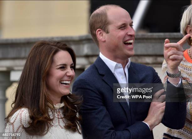 Catherine, Duchess of Cambridge and Prince William, Duke of Cambridge laugh as they host a tea party in the grounds of Buckingham Palace to honour...