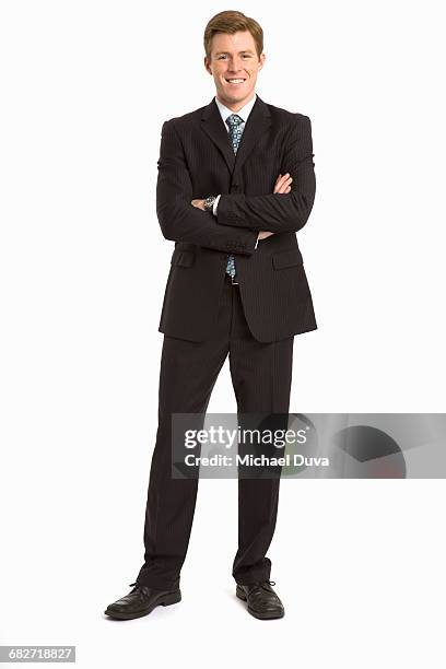 businessman looking at camera w arms folded proud - homme costume photos et images de collection