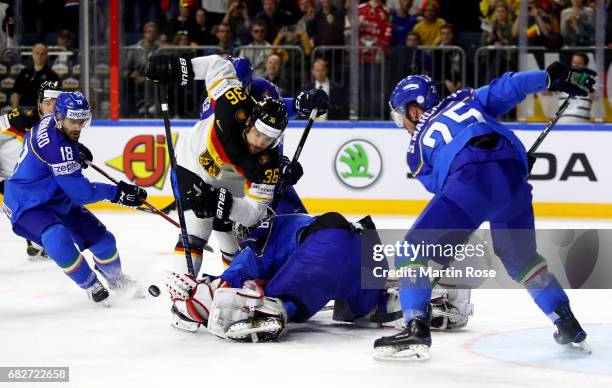 Alex Lambacher of Italy challenges Yannic Seidenberg of Germany for the puck during the 2017 IIHF Ice Hockey World Championship game between Italy...