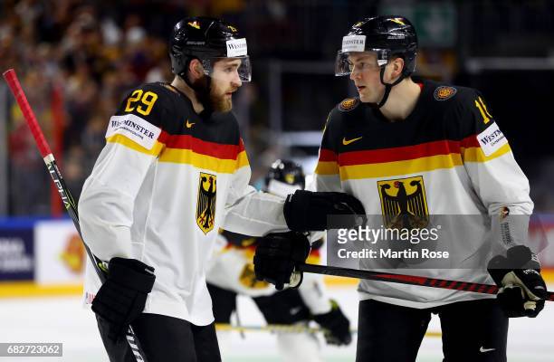 Leon Draisaitl of Germany talks to team mate Konrad Abeltshauser during the 2017 IIHF Ice Hockey World Championship game between Italy and Germany at...