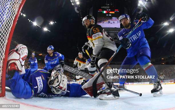 Italy´s Andreas Bernard, Italy´s Marco Insam , Germany´s Felix Schultz vie during the IIHF Ice Hockey World Championships first round match between...