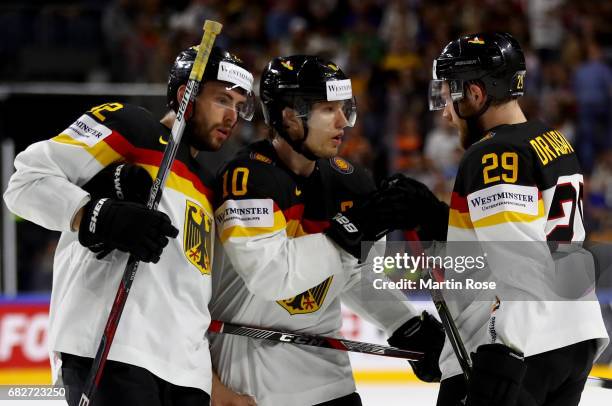 Leon Draisaitl of Germany talks to team mate Matthias Plachta and Christian Ehrhoff during the 2017 IIHF Ice Hockey World Championship game between...