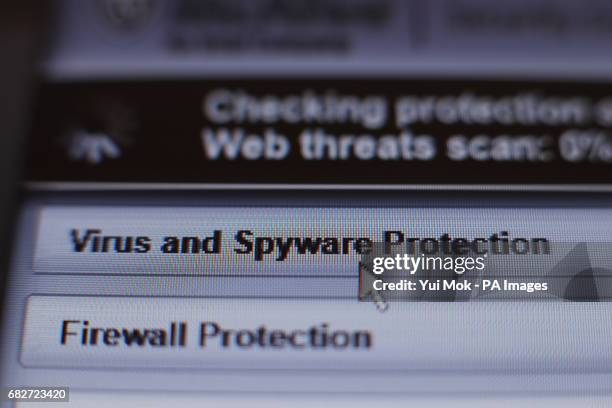 Internet security software performing an anti-virus and anti-spyware scan on a laptop, after the NHS has been hit by a major cyber attack on its...