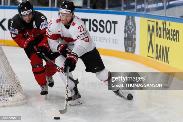 Switzerland's Tanner Richard vies with Canada's Matt Duchene during the IIHF Men's World Championship group B ice hockey match between Canada and...