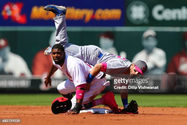 Dexter Fowler of the St. Louis Cardinals is out in a double play against Tommy La Stella of the Chicago Cubs in the first inning at Busch Stadium on...