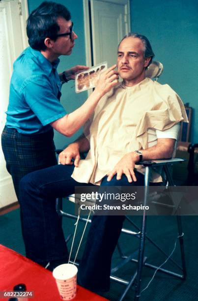 American make-up artist Dick Smith works on actor Marlon Brando to prepare for the latter's role in the film 'The Godfather' , 1972.