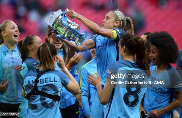 Steph Houghton of Manchester City Women throws champagne from the trophy over her team mates during the SSE Women's FA Cup Final between Birmingham...
