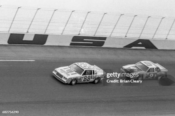 Bobby Allison drives the Buick Regal ahead of Bill Elliott in the Ford Thunderbird during the Firecracker 400 NASCAR race, Daytona International...