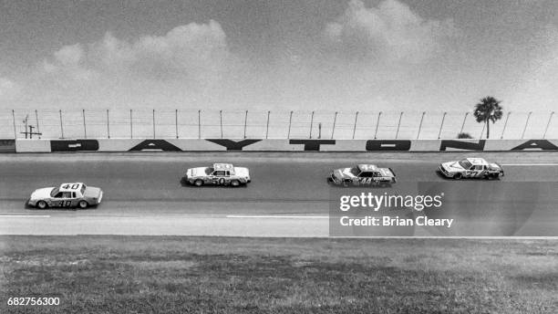 Slick Johnson drives the Buick Regal ahead of Geoff Bodine in the Pontiac Lemans, Terry Labonte in the Buick Regal, and Cale Yarborough in the Buick...