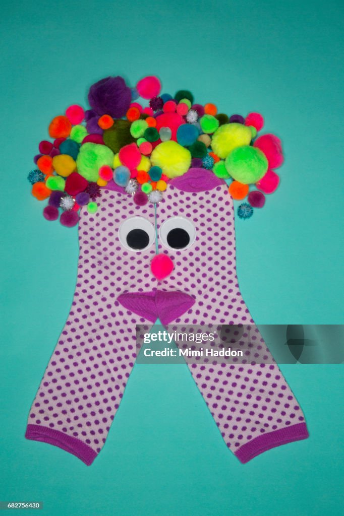 Pair of Polka Dot Socks with Googly Eyes Smiling at Camera