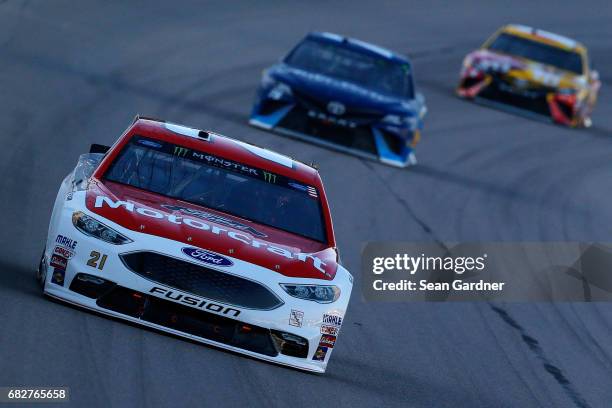 Ryan Blaney, driver of the Motorcraft/Quick Lane Tire & Auto Center Ford, leads Martin Truex Jr., driver of the Auto-Owners Insurance Toyota, and...