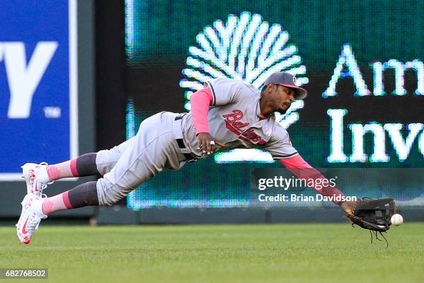 Adam Jones of the Baltimore Orioles attempts to catch the ball but misses during the game against the Kansas City Royals at Kauffman Stadium on May...
