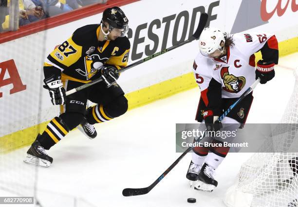 Sidney Crosby of the Pittsburgh Penguins looks for the puck against Erik Karlsson of the Ottawa Senators during the second period in Game One of the...