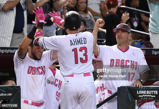 Nick Ahmed of the Arizona Diamondbacks celebrates with manager Torey Lovullo and David Peralta after hitting a solo home run off of Trevor Williams...