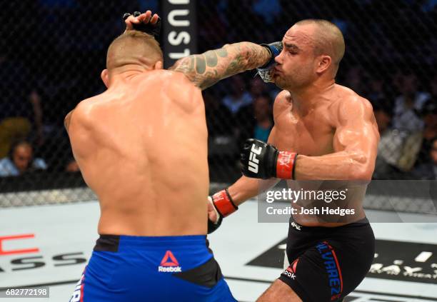 Dustin Poirier punches Eddie Alvarez in their lightweight fight during the UFC 211 event at the American Airlines Center on May 13, 2017 in Dallas,...