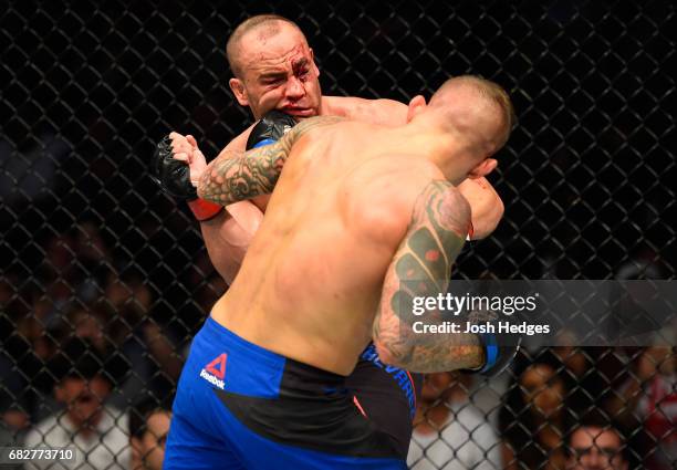 Dustin Poirier punches Eddie Alvarez in their lightweight fight during the UFC 211 event at the American Airlines Center on May 13, 2017 in Dallas,...