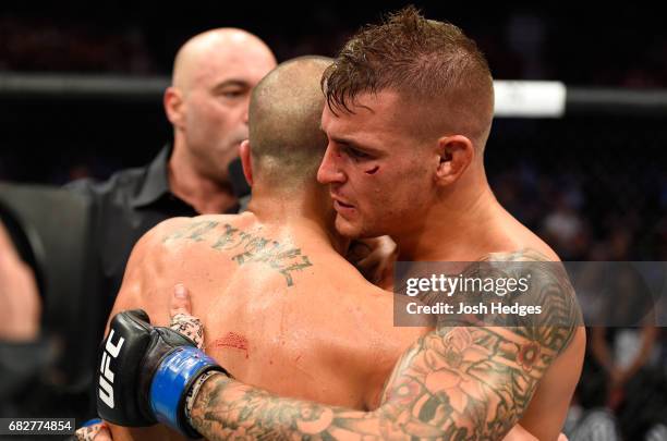 Dustin Poirier hugs Eddie Alvarez in their lightweight fight during the UFC 211 event at the American Airlines Center on May 13, 2017 in Dallas,...