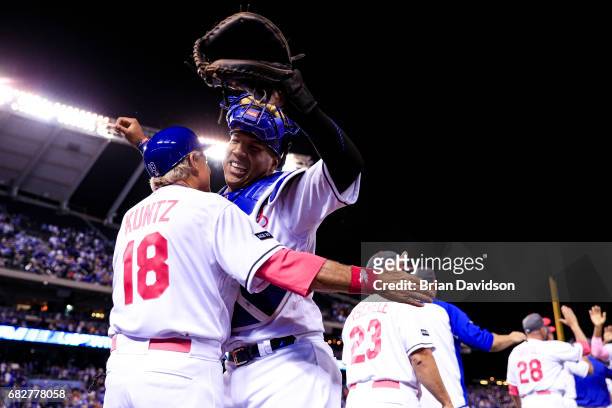 First base coach Rusty Kuntz and Salvador Perez of the Kansas City Royals celebrate defeating the Baltimore Orioles 4-3 at Kauffman Stadium on May...