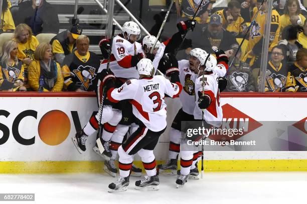 Bobby Ryan of the Ottawa Senators celebrates with his teammates after scoring a goal against Marc-Andre Fleury of the Pittsburgh Penguins in overtime...