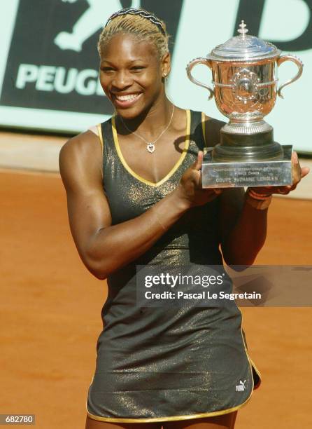 Serena Williams of the USA poses with the winner's cup after winning the French Open against her sister Venus on June 8, 2002 at the Roland Garros...