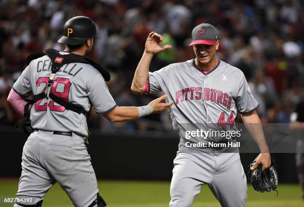 Tony Watson and Francisco Cervelli of the Pittsburgh Pirates celebrate a 4-3 win against the Arizona Diamondbacks at Chase Field on May 13, 2017 in...