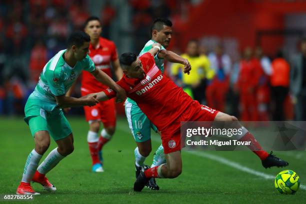 Rubens Sambueza of Toluca fights for the ball with Jorge Sanchez of Santos during the quarter finals second leg match between Toluca and Santos...