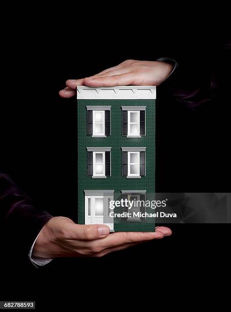 hands holding model residential building - auction property stock pictures, royalty-free photos & images