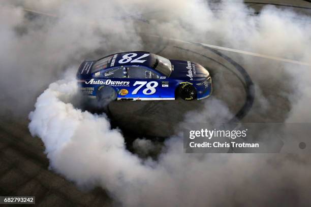 Martin Truex Jr., driver of the Auto-Owners Insurance Toyota, celebrates with a burnout after winning the Monster Energy NASCAR Cup Series Go Bowling...