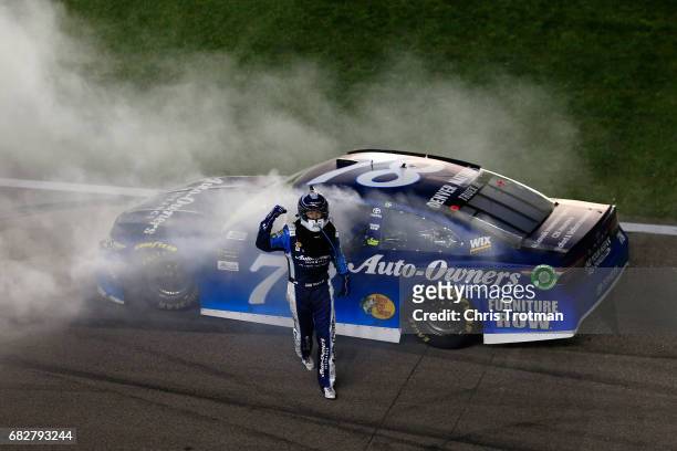 Martin Truex Jr., driver of the Auto-Owners Insurance Toyota, celebrates with a burnout after winning the Monster Energy NASCAR Cup Series Go Bowling...