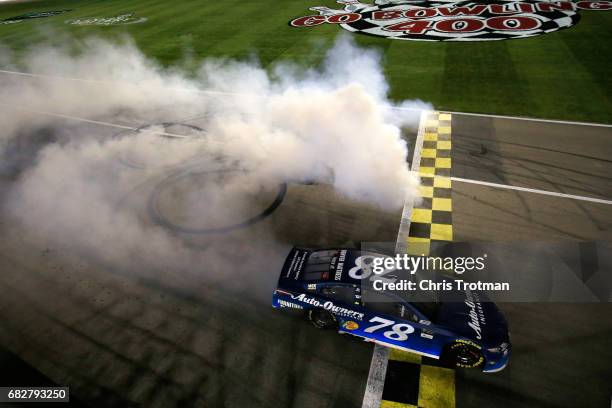 Martin Truex Jr., driver of the Auto-Owners Insurance Toyota, celebrates with a burnout after winning the Monster Energy NASCAR Cup Series Go Bowling...