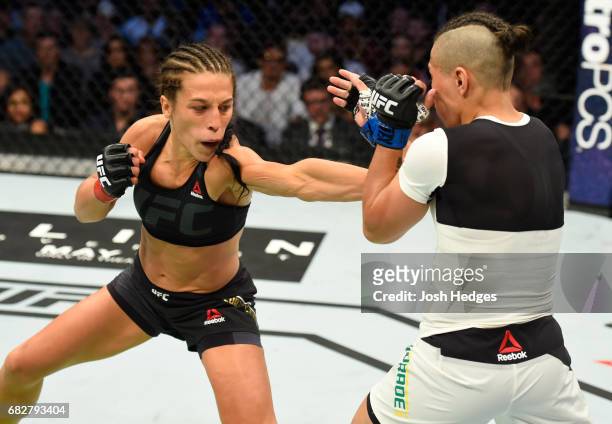 Joanna Jedrzejczyk punches Jessica Andrade in their UFC women's strawweight championship fight during the UFC 211 event at the American Airlines...