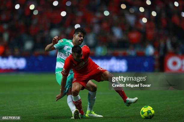 Enrique Triverio of Toluca fights for the ball with Nestor Araujo of Santos during the quarter finals second leg match between Toluca and Santos...