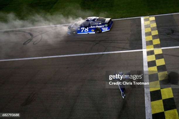 Martin Truex Jr., driver of the Auto-Owners Insurance Toyota, celebrates after a burnout after winning the Monster Energy NASCAR Cup Series Go...