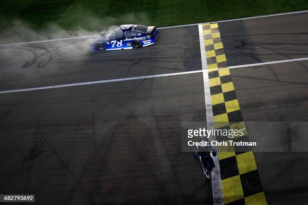 Martin Truex Jr., driver of the Auto-Owners Insurance Toyota, celebrates after a burnout after winning the Monster Energy NASCAR Cup Series Go...