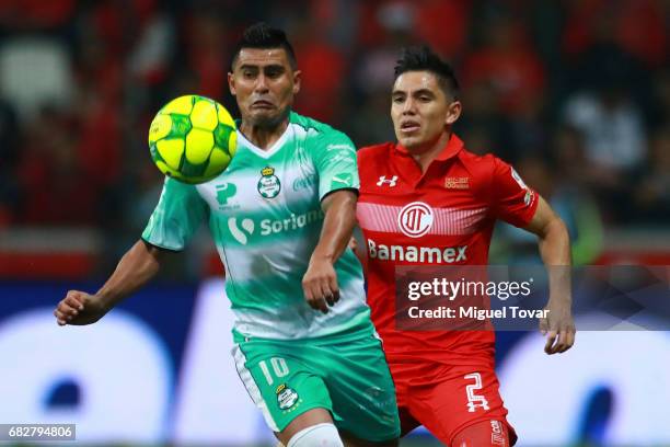 Efrain Velarde of Toluca fights for the ball with Osvaldo Martinez of Santos during the quarter finals second leg match between Toluca and Santos...
