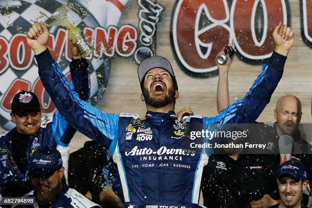 Martin Truex Jr., driver of the Auto-Owners Insurance Toyota, celebrates in Victory Lane after winning the Monster Energy NASCAR Cup Series Go...