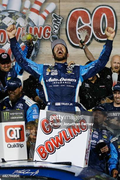 Martin Truex Jr., driver of the Auto-Owners Insurance Toyota, celebrates in Victory Lane after winning the Monster Energy NASCAR Cup Series Go...